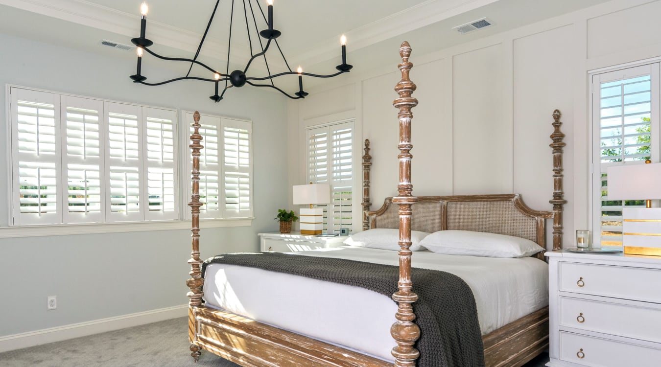  Plantation shutters in a bedroom.